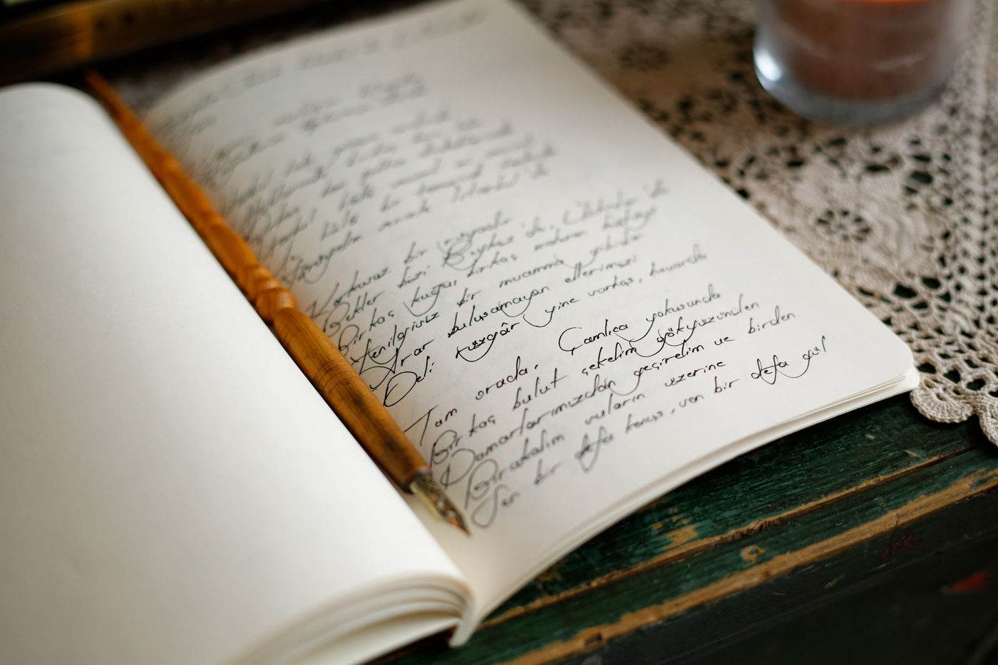 Handwritten wedding vows on notebook paper next to a pen and a small bouquet