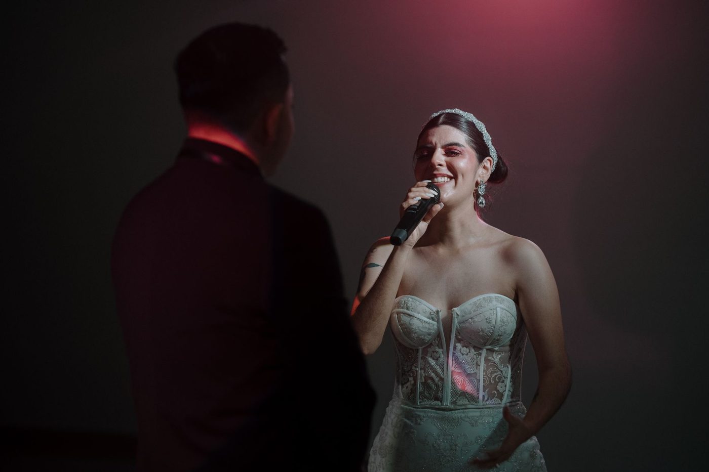 Bride and groom laughing together while exchanging vows at their ceremony