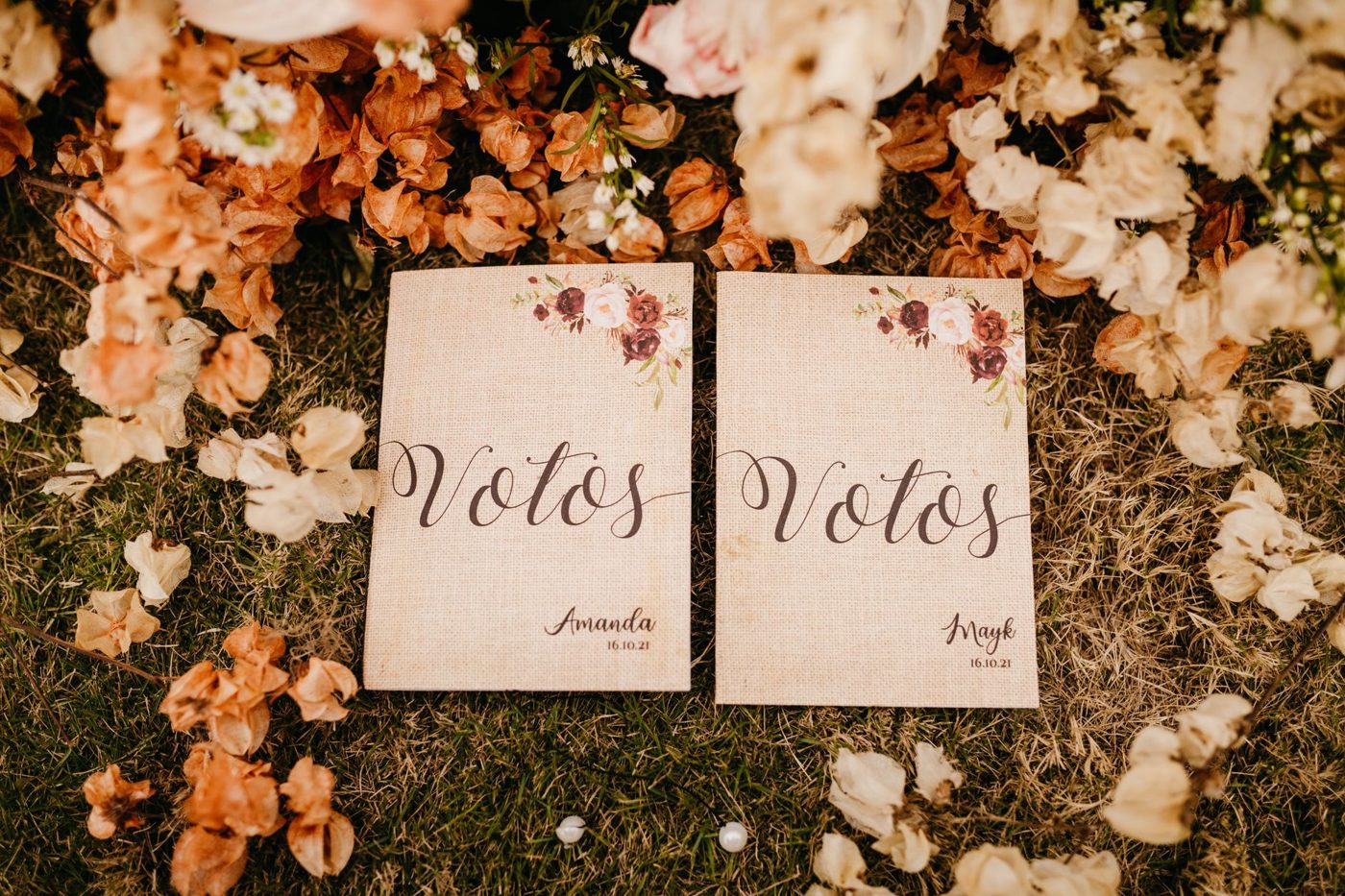 Handwritten wedding vows on small cards next to a bouquet and wedding rings