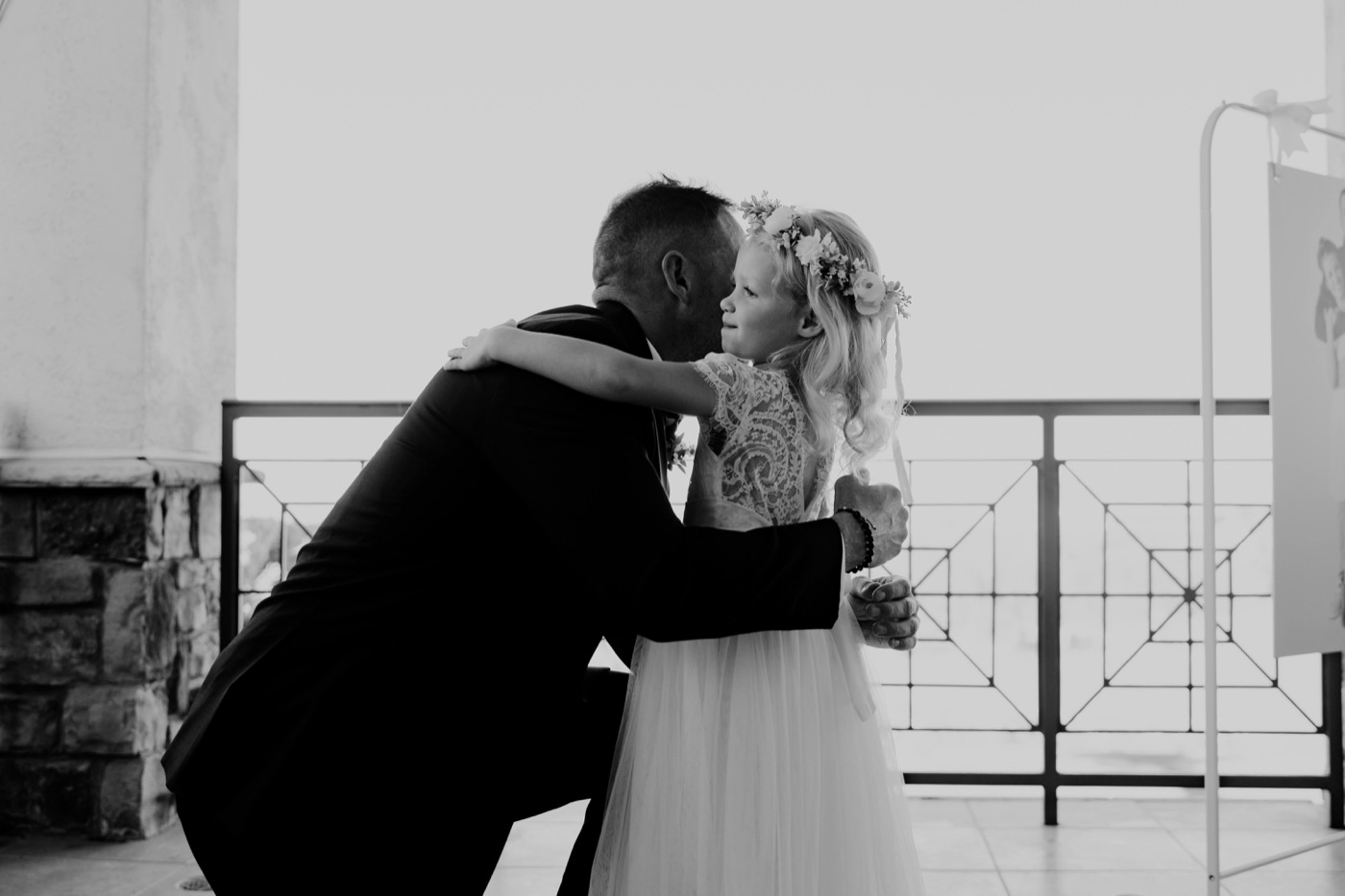 Father and daughter sharing a heartwarming embrace at a wedding ceremony