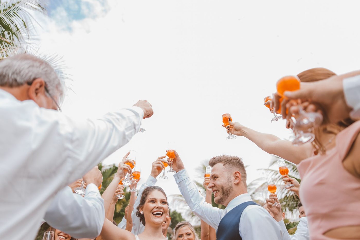 Best man and groomsmen raising their glasses during a wedding reception toast