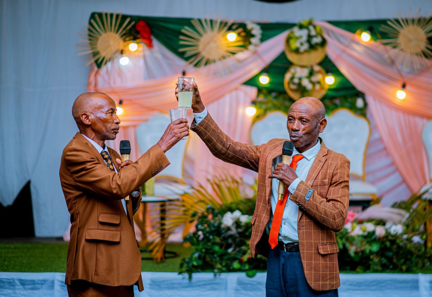 Best man giving a toast to the couple at a wedding reception while guests listen