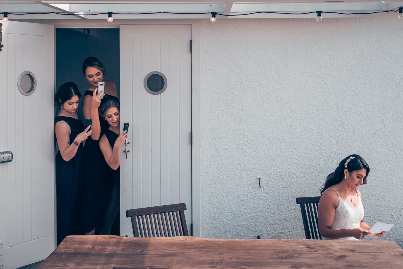 Bride holding a small card with handwritten wedding vows just before reading them