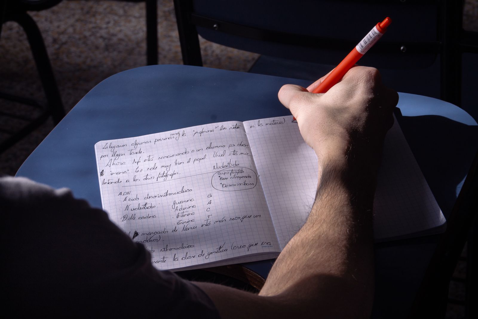 Close-up of a hand writing wedding speech notes in a notebook