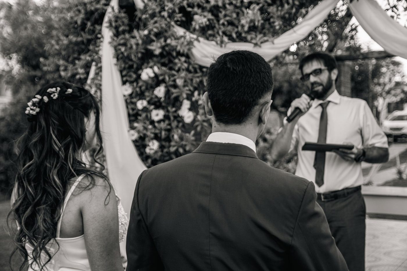 Groom reading his vows to his bride during an outdoor wedding ceremony