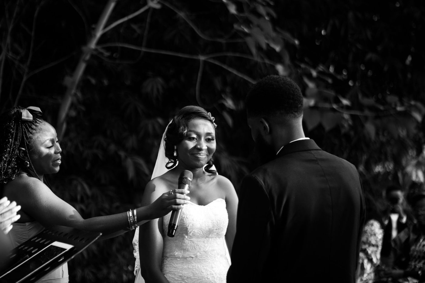 Couple facing each other and exchanging vows during an outdoor wedding ceremony