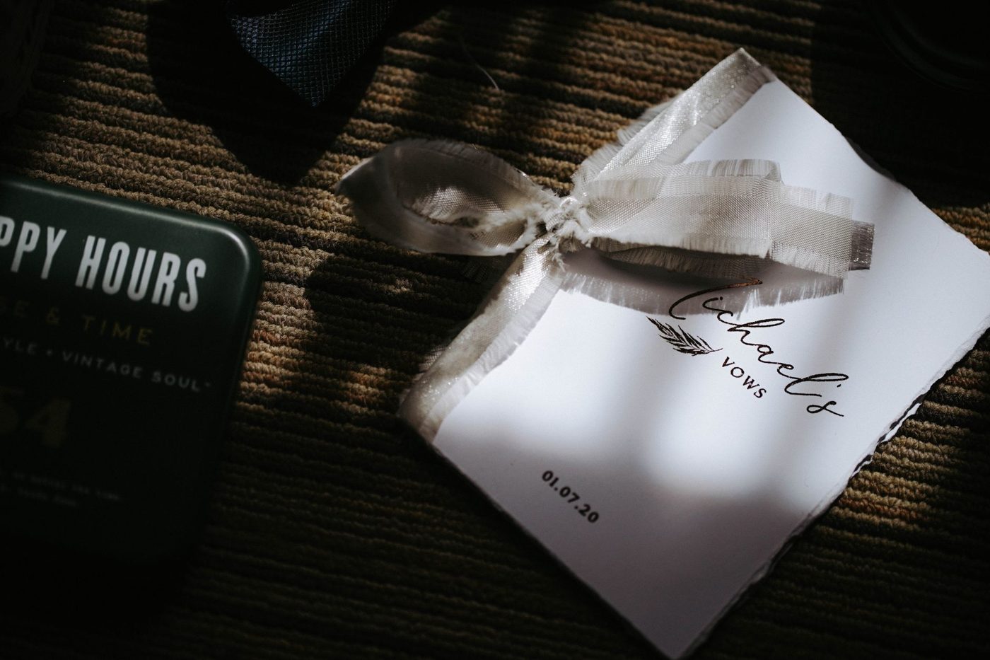 Hands holding printed wedding vow cards before the ceremony