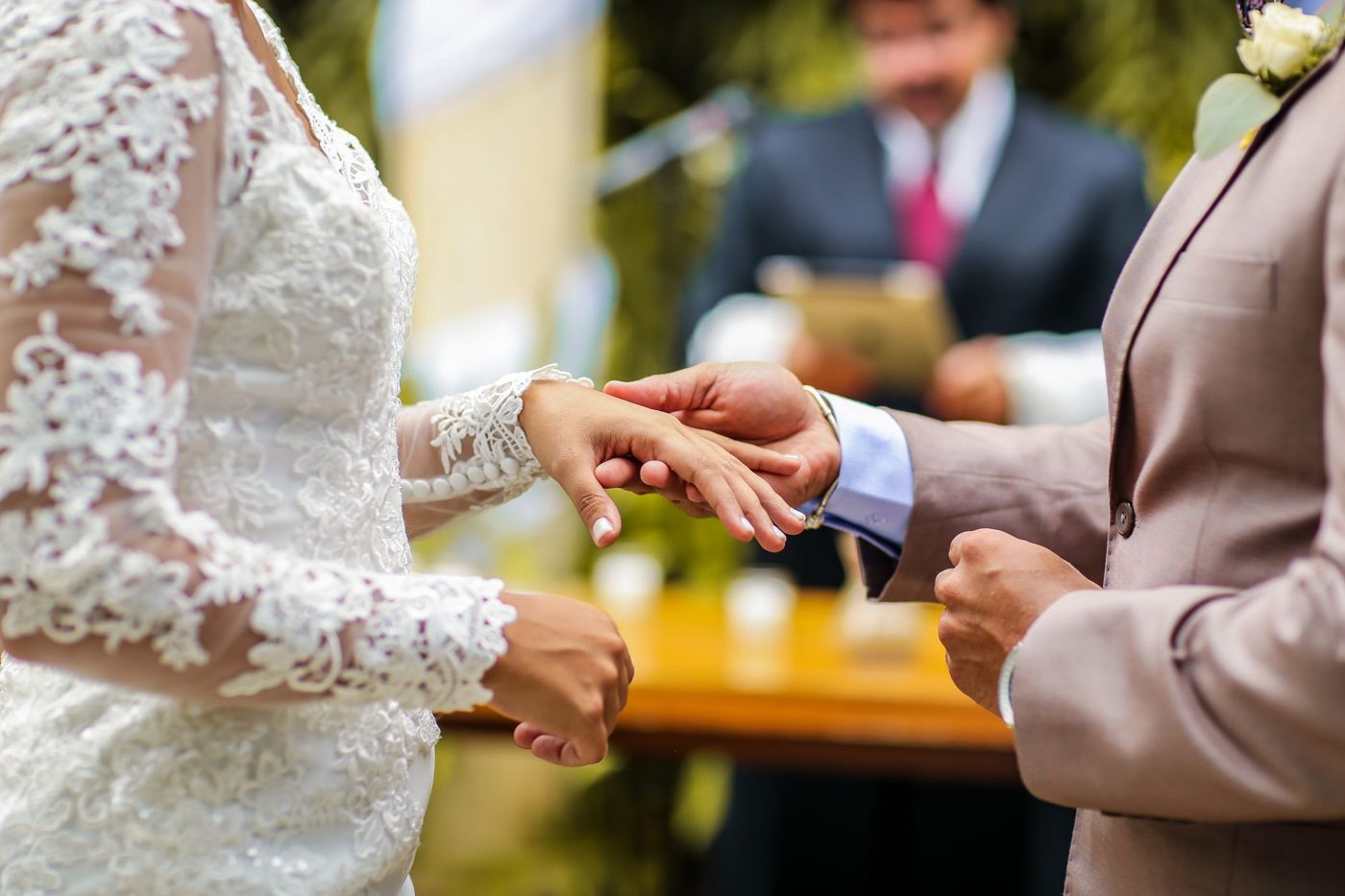 Couple facing each other and exchanging vows during an outdoor wedding ceremony