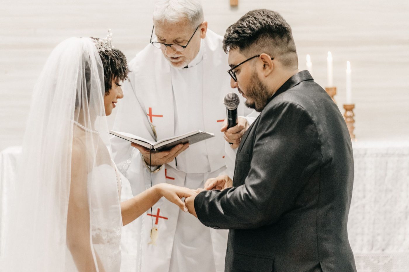 Officiant standing with a couple as they say their wedding vows to each other