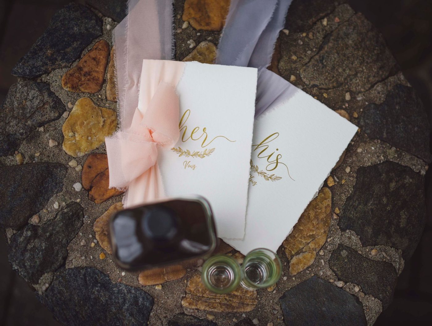 Handwritten wedding vows on a card next to a pen and a small bouquet