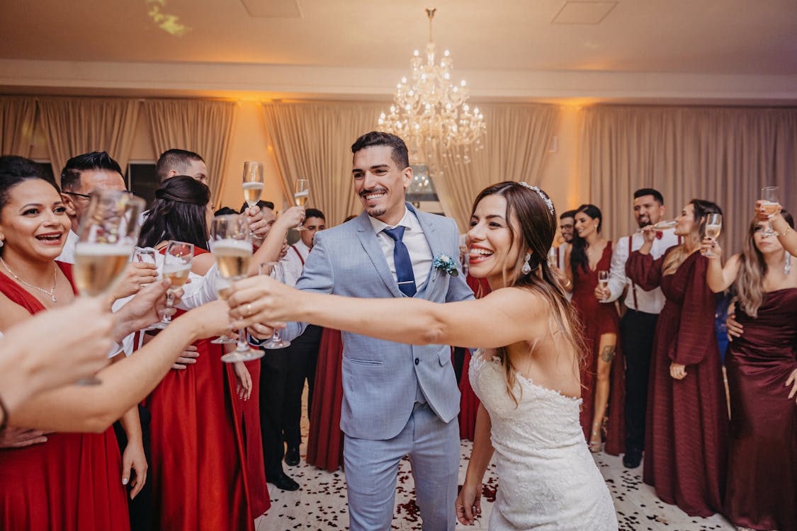 Wedding guests raising champagne glasses during a toast at a reception