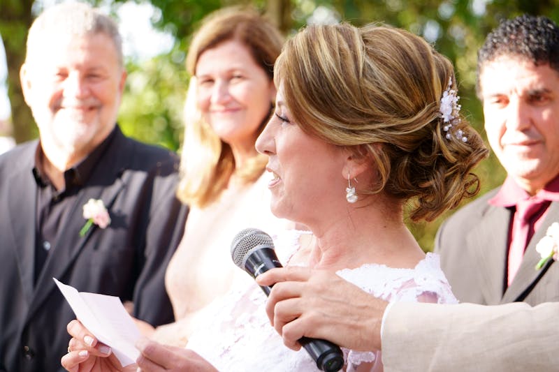 Wedding guests laughing and celebrating during a reception toast