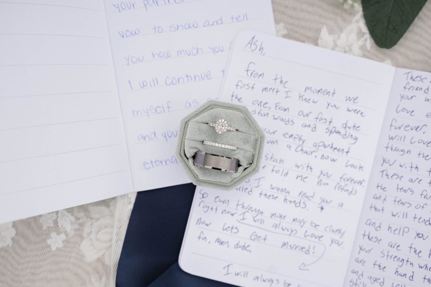 Handwritten wedding vows on a card resting next to a pen and a small bouquet