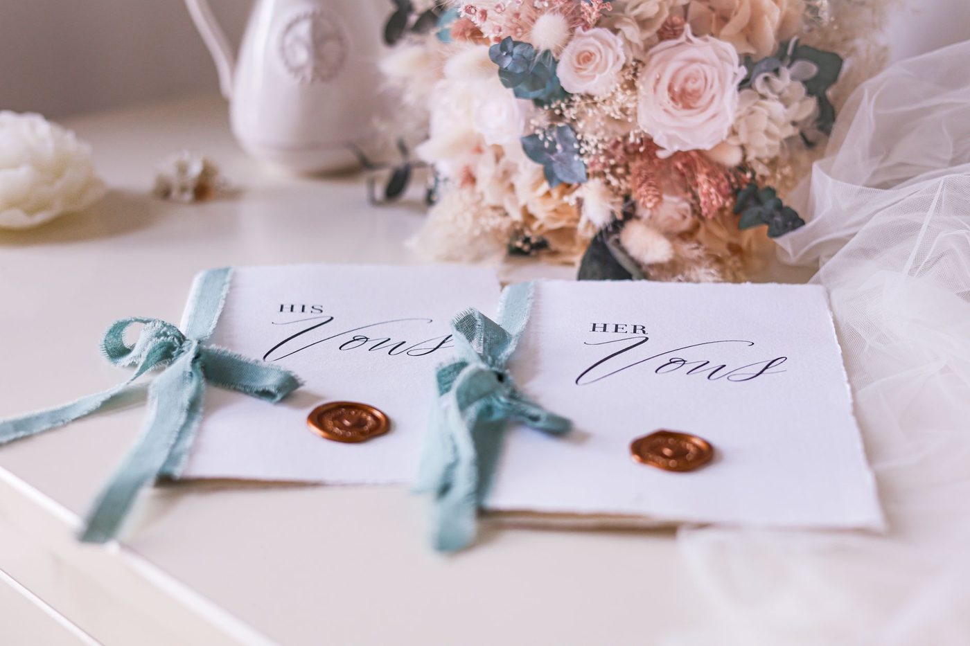 Handwritten wedding vows on small cards next to a bouquet